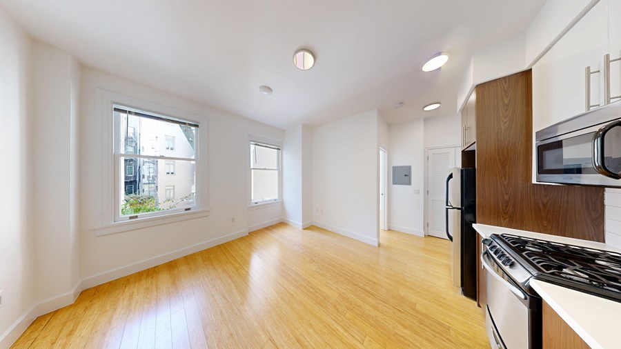 A kitchen with a stove top oven and microwave.